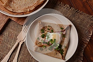 Breton galette, galette sarrasin, buckwheat crepe, with fried egg, cheese, ham.