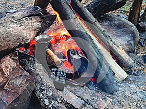 Brew coffee in a Turk on an open fire.
