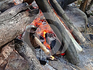 Brew coffee in a Turk on an open fire.