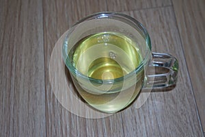 Brewed fragrant green tea or qehwa or qahwa on the wooden floor