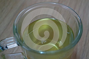 Brewed fragrant green tea or qehwa or qahwa on the wooden floor