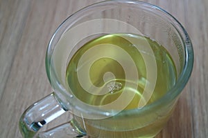 Brewed fragrant green tea or qehwa or qahwa on the wooden floor