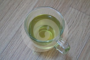 Brewed fragrant green tea or qehwa or qahwa on the wooden floor