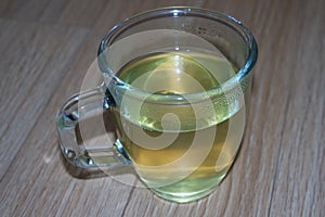 Brewed fragrant green tea or qehwa or qahwa on the wooden floor