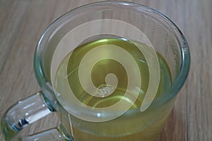 Brewed fragrant green tea or qehwa or qahwa on the wooden floor