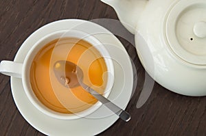 Brewed green tea in glass mug and teapot in cafe in natural light