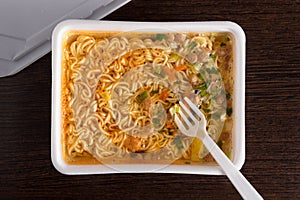 Brewed instant noodles in plastic packaging, close-up, top view,.junk food, fast food