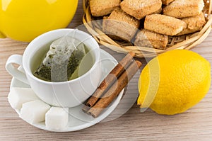 Brewed tea, sugar and cinnamon, lemon and shortbread cookies