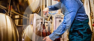 Brewer filling beer in bottle