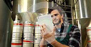 Brewer using digital tablet in brewery factory 4k