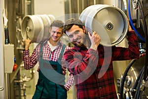 Brewers carrying keg on shoulder