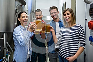 Brewers toasting beers at brewery