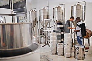 Brewery, production and people with steel in factory or distillery for winery, alcohol and drink manufacturing. Worker