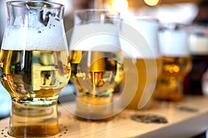 Brewery tasting with five glasses of different color and opacity of the drink. Blurred and indistinguishable background of the
