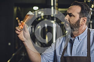 Brewery worker with glass of beer