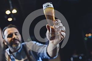 Brewery worker with glass of beer