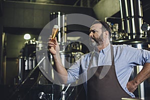 Brewery worker with glass of beer