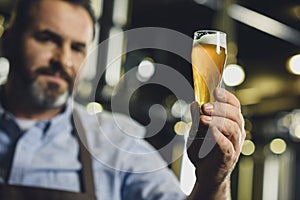 Brewery worker with glass of beer