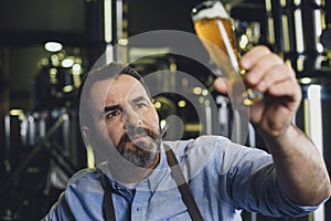 Brewery worker with glass of beer