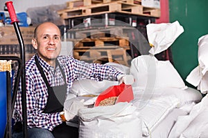 Brewery worker holding large bags