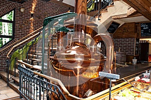 A brewing kettle of copper in a beer brewery