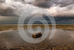 A brewing storm on an ocean sunset