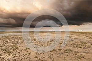 A brewing storm on an ocean sunset