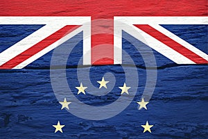 Brexit concept. Flags of the United Kingdom and the European Union on cracked grunge wall background. Possible exit of