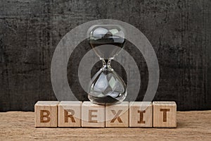 Brexit, time countdown for the UK to deal and withdraw from Euro zone concept, sandglass or hourglass on wooden cube block with