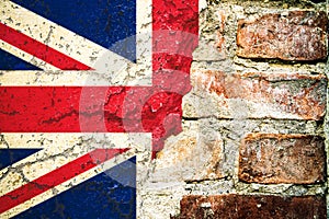 Brexit: United Kingdom UK flag flag painted cracked divided peeling paint brick wall cement facade Brexit concept.