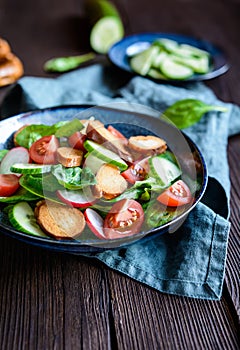Brezensalat - traditional German pretzel salad with spinach, tomatoes, radish and cucumber