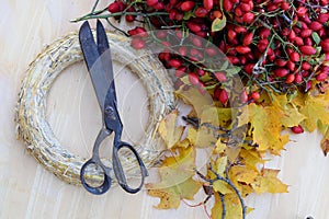 Briar and leaves wreath ingredients on wooden table