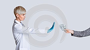 Bribe concept. Strict doctor dont takes money of patient