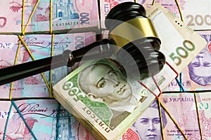 Bribes and corruption in Ukrainian court. Gavel on stacks of hryvnia