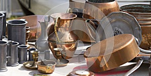 Bric-a-brac of copper and tin objects at flea market