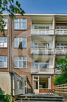 a brick apartment building with balconies and a staircase