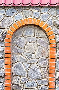 Brick arch in the stone wall