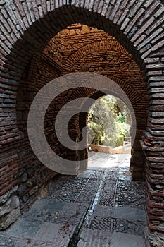 Brick arches inside the Alcazaba of Malaga. Palatial fortification from the Islamic era built in the 11th century