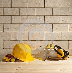 Brick background, helmet and trowel