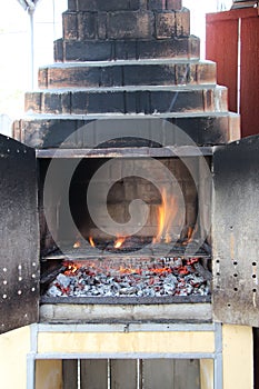 Brick barbecue with flames ready to be used