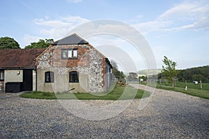 Brick Barn House and Surrounding Gravel Driveway