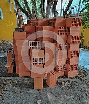 Brick blocks piled up over one another in a construction site. photo