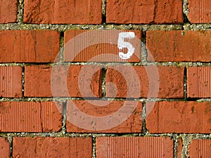 Brick wall with numeral 5