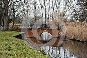 A brick bridge over a canal.