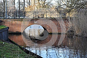 A brick bridge over a canal.