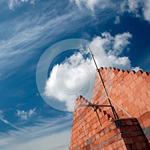 Brick building and cloudscape