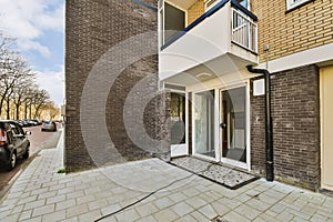 a brick building with a glass door and a sidewalk