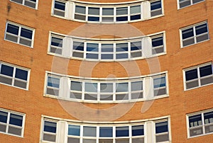 Brick building round windows corner, office or hospital, orange wall