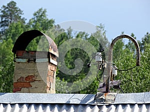 Brick chimney and electric distributor on the roof