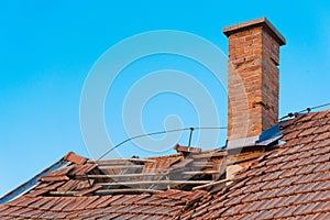 Brick chimney on old abandoned roof